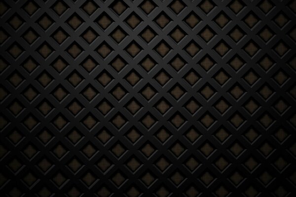 Grille noire sur fond de mur brun
