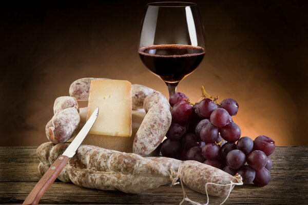 Image de vin rouge, raisin, fromage et salami